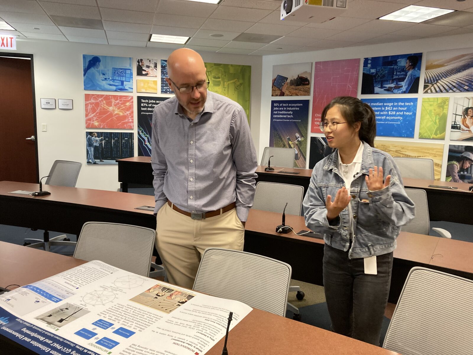 Graduate student intern Shiyu Liu explains her research project to Karl Putz, DPIâ€™s associate director of R&D. 