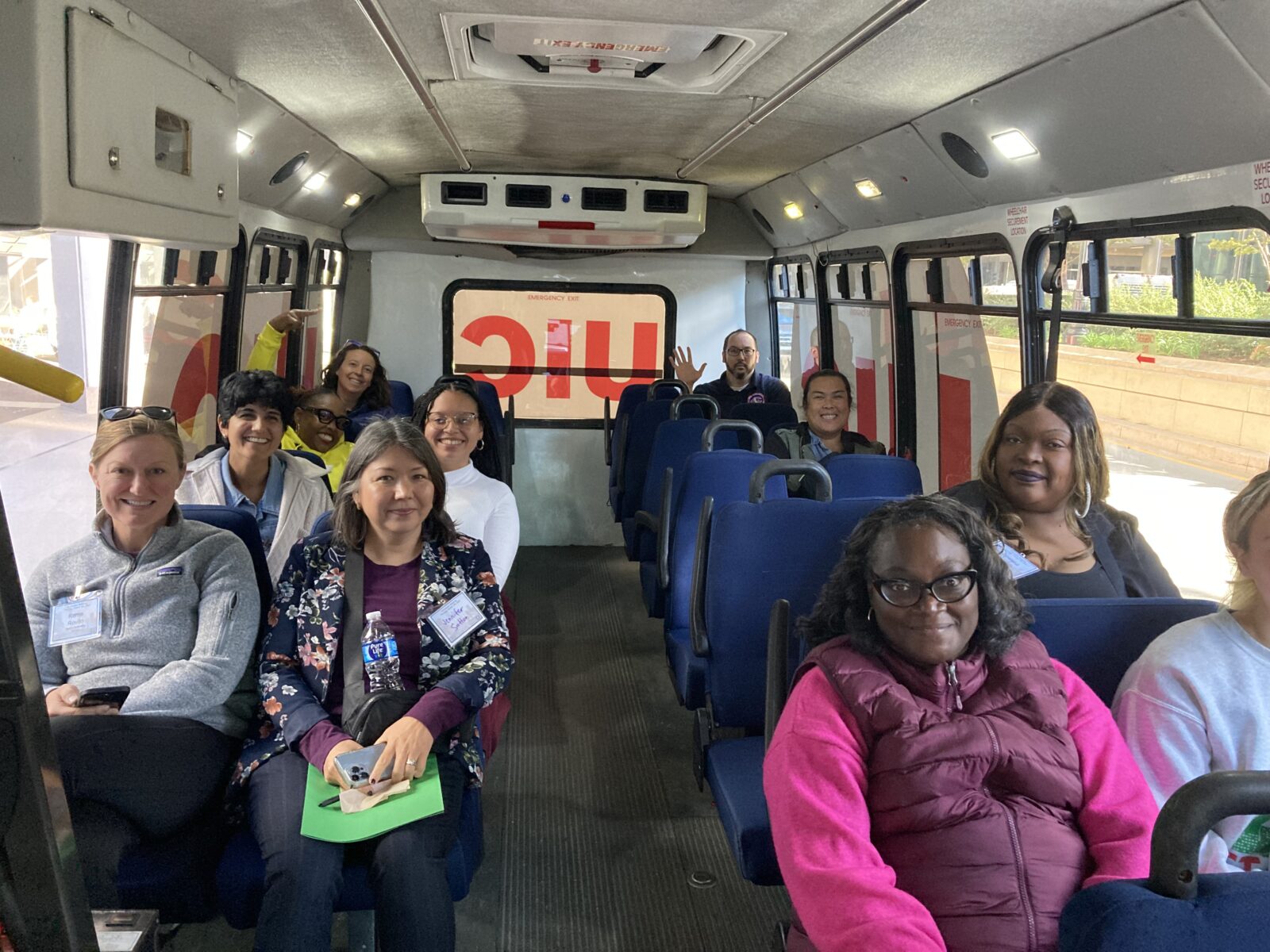 A group of workshop participants waits on the bus to the Amazon facility.