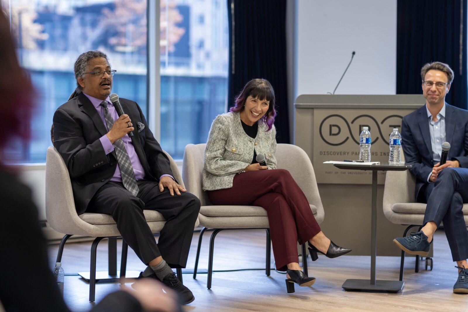 Reggie Gaudino speaks at the CRI riverside chat as Rep. Eva-Dina Delgado and Nathaniel Inglis Steinfeld listen. 
