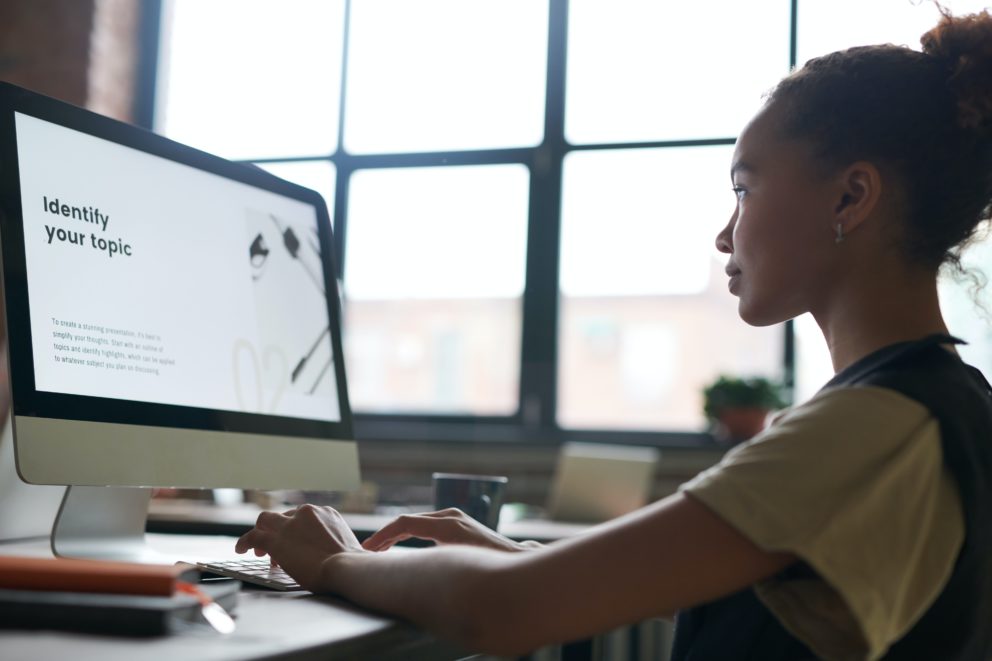 Young woman working at computer in a classroom