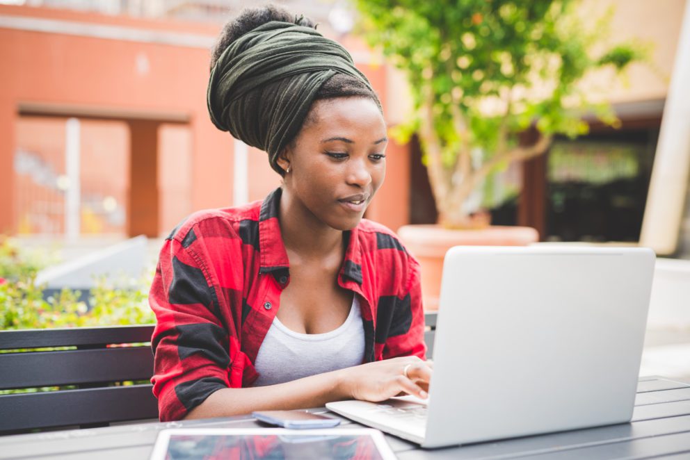 Woman working outside with laptop