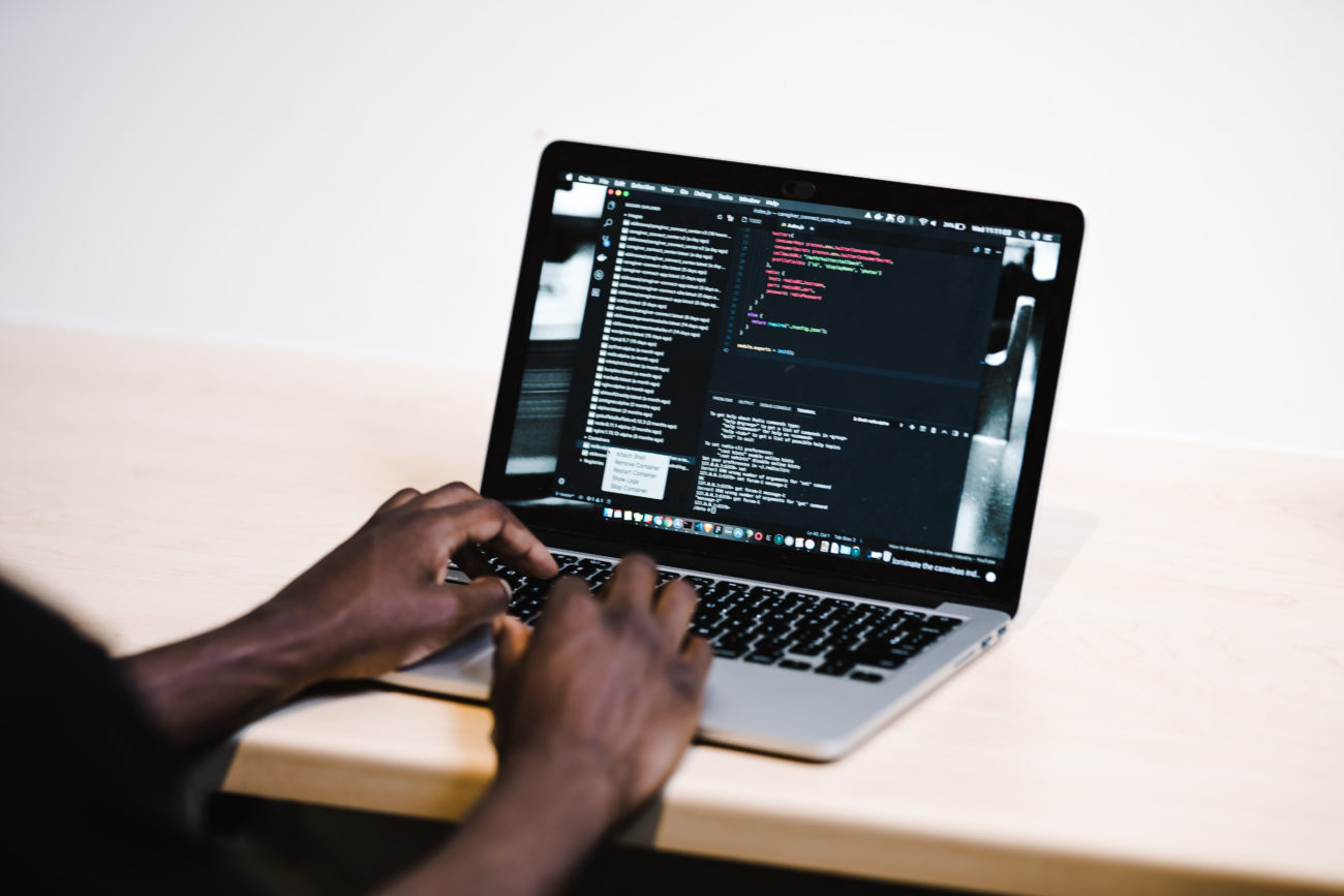 hands coding on laptop