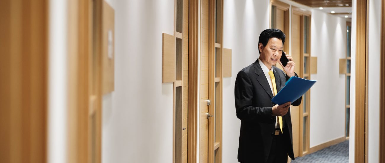 Businessman in hallway on phone